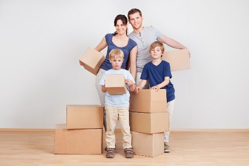 Professional movers handling office furniture in central London