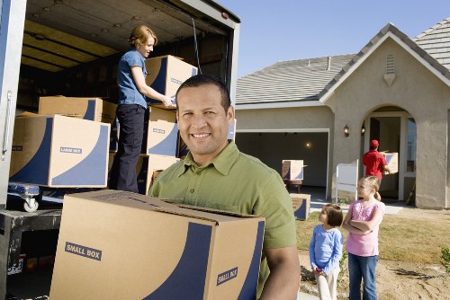 Removal professionals navigating a central London property access area