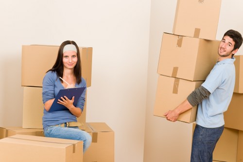 Moving crew handling furniture and fragile items in a luxury London property